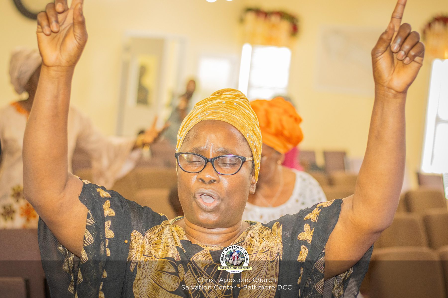 A worshipper with hand raised